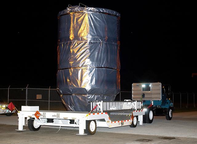 NASA image: KENNEDY SPACE CENTER, FLA. -  The Mars Exploration Rover 1 (MER-B) is moved  out of the Payload Hazardous Servicing Facility for transfer to Launch Pad 17-B, Cape Canaveral Air Force Station.  The second of twin rovers being sent to Mars, it is equipped with a robotic arm, a drilling tool, three spectrometers, and four pairs of cameras that allow it to have a human-like, 3D view of the terrain. Each rover could travel as far as 100 meters in one day to act as Mars scientists' eyes and hands, exploring an environment where humans can't yet go.  MER-B is scheduled to launch June 26 at one of two available times,  12:27:31 a.m. EDT or 1:08:45 a.m. EDT.