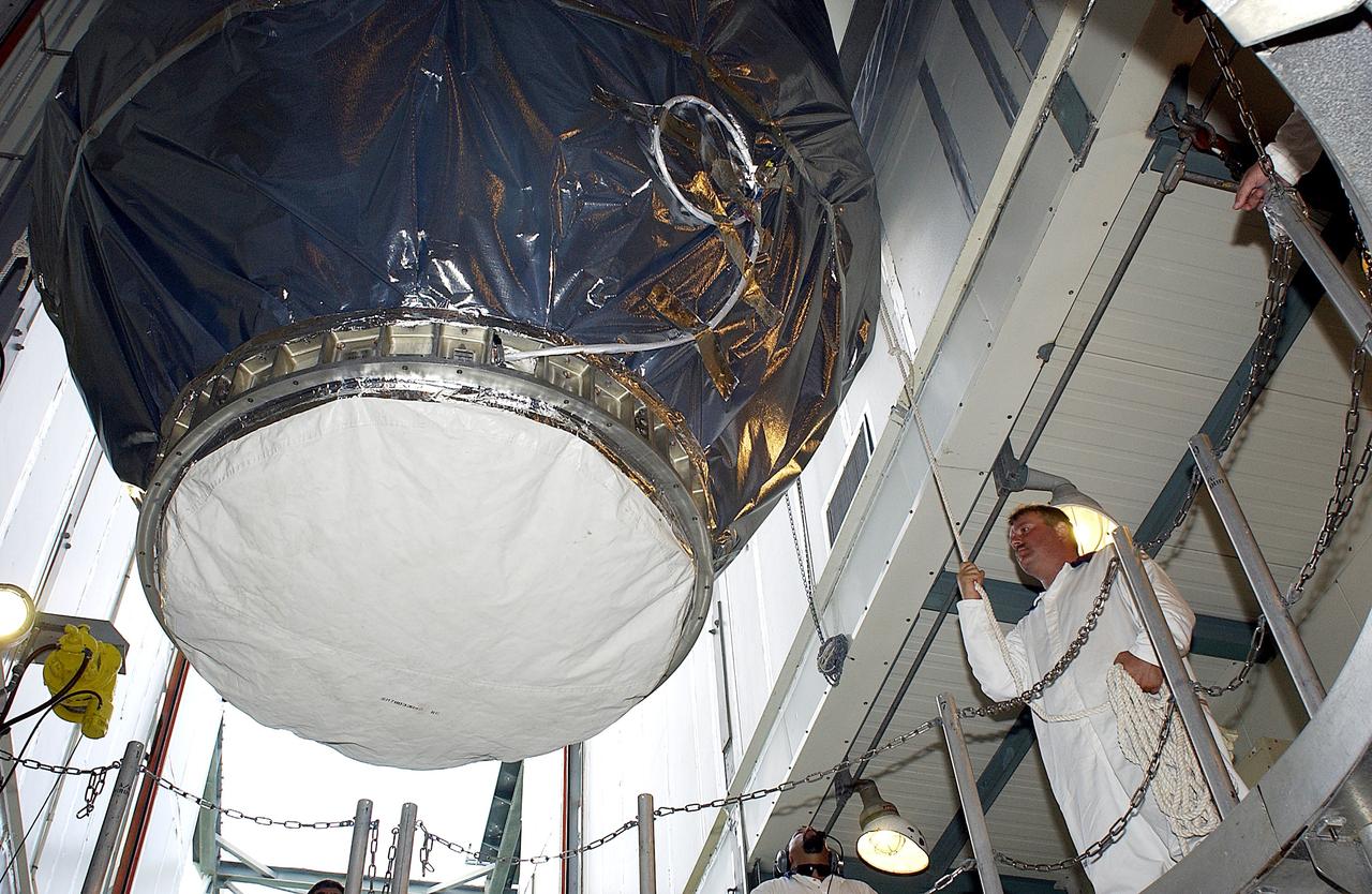 KENNEDY SPACE CENTER, FLA. -   On Launch Pad 17-B, Cape Canaveral Air Force Station, the Mars Exploration Rover 1 (MER-B) is lowered toward the Delta rocket for mating.  The second of twin rovers being sent to Mars, it is equipped with a robotic arm, a drilling tool, three spectrometers, and four pairs of cameras that allow it to have a human-like, 3D view of the terrain. Each rover could travel as far as 100 meters in one day to act as Mars scientists' eyes and hands, exploring an environment where humans can't yet go.  MER-B is scheduled to launch June 26 at one of two available times,  12:27:31 a.m. EDT or 1:08:45 a.m. EDT.
