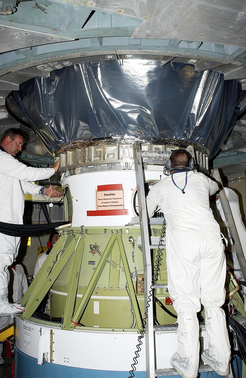 KENNEDY SPACE CENTER, FLA. -    Workers on Launch Pad 17-B, Cape Canaveral Air Force Station, complete mating of the Mars Exploration Rover 1 (MER-B), above, to the Delta rocket below.  The second of twin rovers being sent to Mars, it is equipped with a robotic arm, a drilling tool, three spectrometers, and four pairs of cameras that allow it to have a human-like, 3D view of the terrain. Each rover could travel as far as 100 meters in one day to act as Mars scientists' eyes and hands, exploring an environment where humans can't yet go.  MER-B is scheduled to launch June 26 at one of two available times,  12:27:31 a.m. EDT or 1:08:45 a.m. EDT.
