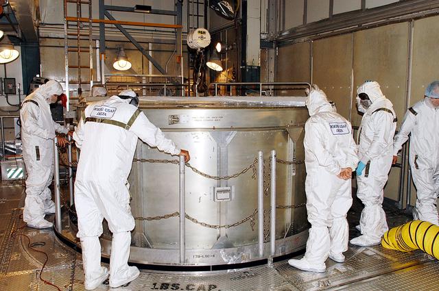 NASA image: KENNEDY SPACE CENTER, FLA. -   In the gantry on Launch Complex 17-B, Cape Canaveral Air Force Station, workers start removing the canister from around the Mars Exploration Rover 1 (MER-B).  The second of twin rovers being sent to Mars, it is equipped with a robotic arm, a drilling tool, three spectrometers, and four pairs of cameras that allow it to have a human-like, 3D view of the terrain. Each rover could travel as far as 100 meters in one day to act as Mars scientists' eyes and hands, exploring an environment where humans can't yet go.  MER-B is scheduled to launch June 26 at one of two available times,  12:27:31 a.m. EDT or 1:08:45 a.m. EDT.