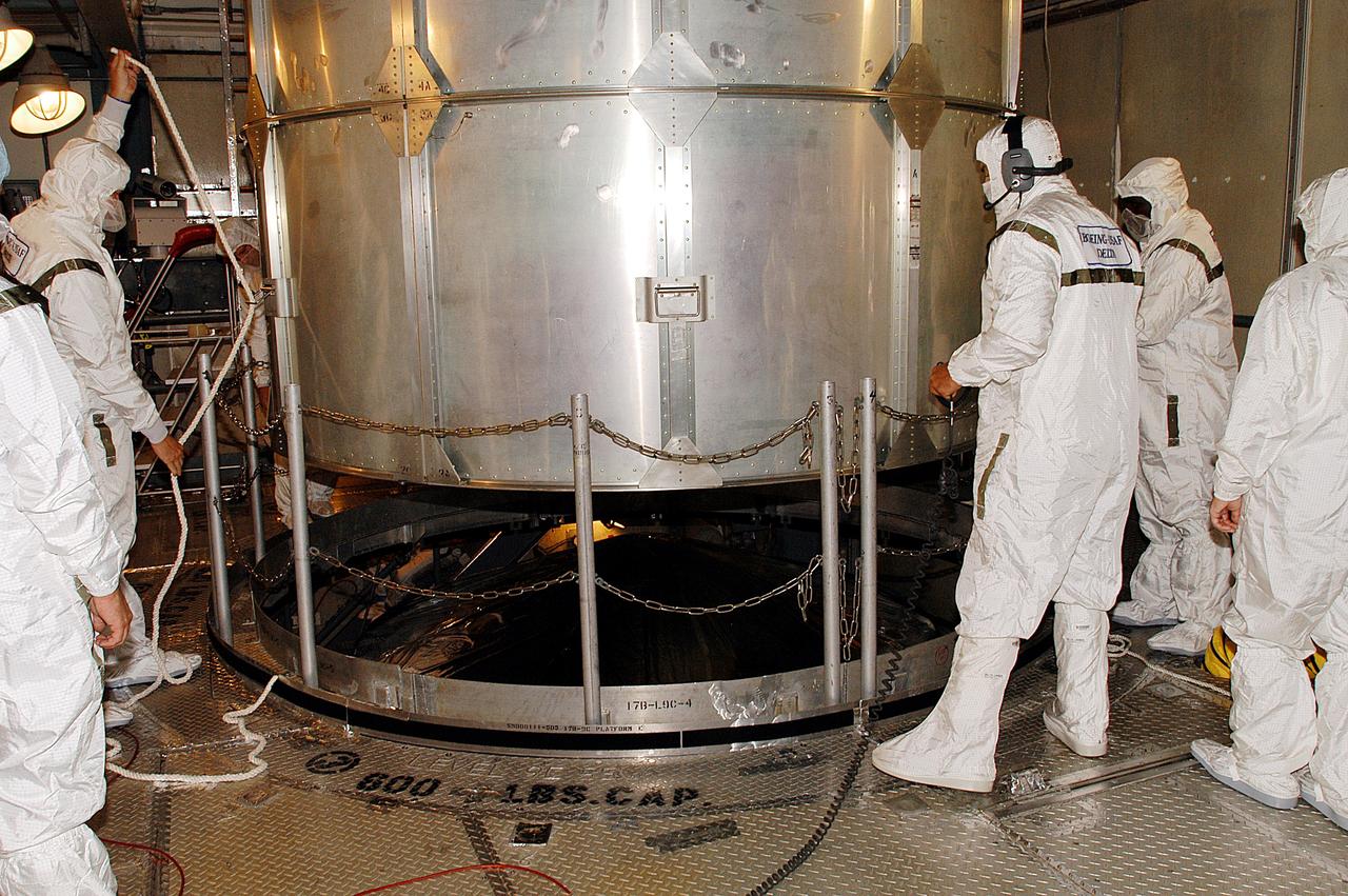KENNEDY SPACE CENTER, FLA. -   The canister is lifted off the Mars Exploration Rover 1 (MER-B) in the gantry on Launch Complex 17-B, Cape Canaveral Air Force Station.  The second of twin rovers being sent to Mars, it is equipped with a robotic arm, a drilling tool, three spectrometers, and four pairs of cameras that allow it to have a human-like, 3D view of the terrain. Each rover could travel as far as 100 meters in one day to act as Mars scientists' eyes and hands, exploring an environment where humans can't yet go.  MER-B is scheduled to launch June 26 at one of two available times,  12:27:31 a.m. EDT or 1:08:45 a.m. EDT.