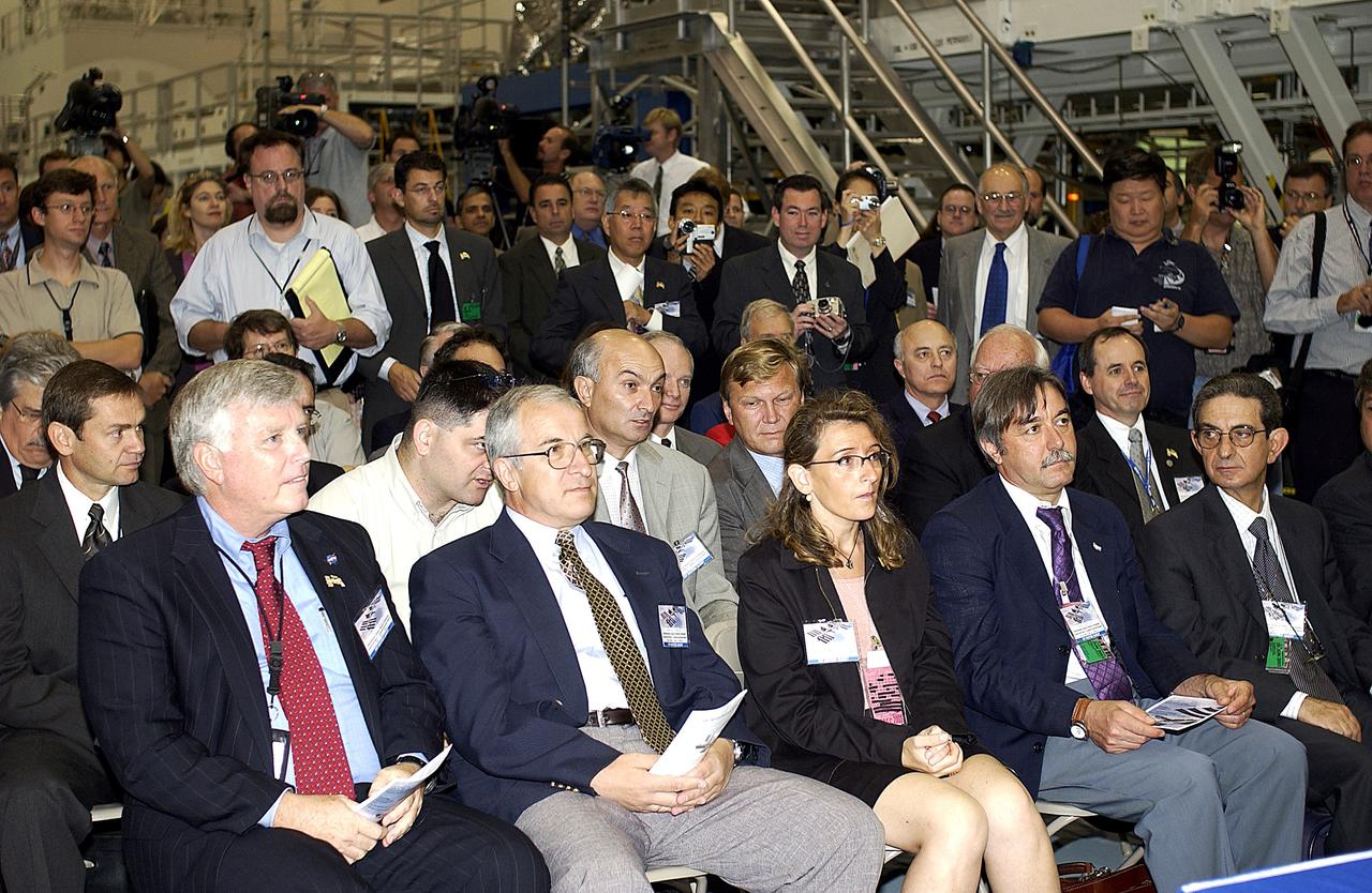 KENNEDY SPACE CENTER, FLA. -  In the Space Station Processing Facility, media and guests listen intently to remarks during a ceremony to highlight the arrival of two major components of the International Space Station.  NASA's Node 2, built by the European Space Agency (ESA) in Italy arrived at KSC on June 1. It will be the next pressurized module installed on the Station. The pressurized module of the Japanese Experiment Module (JEM), named "Kibo" (Hope) arrived at KSC on June 4. It is Japan's primary contribution to the Station. The ceremony held today included the official transfer of ownership signing of Node 2 between the ESA and NASA.. Emceed by Lisa Malone,  deputy director of External Relations and Business Development at KSC, the ceremony included these speakers: KSC Director Roy Bridges Jr.; NASA's Michael C. Kostelnik, deputy associate administrator for International Space Station and Shuttle Programs, and William Gerstenmaier, International Space Station Program manager; Alan Thirkettle, International Space Station Program manager for Node 2, ESA; Andrea Lorenzoni, International Space Station Program manager for Node 2, Italian Space Agency; Kuniaki Shiraki, JEM Project manager, National Aerospace and Development Agency of Japan.