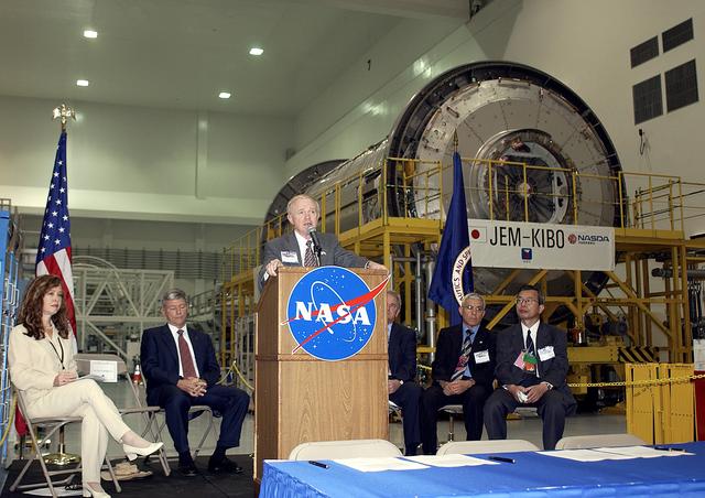 NASA image: KENNEDY SPACE CENTER, FLA. -  Center Director Roy Bridges Jr. speaks to the media and guests gathered in the Space Station Processing Facility for a ceremony to highlight the arrival of two major components of the International Space Station.  NASA's Node 2, built by the European Space Agency (ESA) in Italy arrived at KSC on June 1. It will be the next pressurized module installed on the Station. The pressurized module of the Japanese Experiment Module (JEM), named "Kibo" (Hope) arrived at KSC on June 4. It is Japan's primary contribution to the Station. The ceremony held today included the official transfer of ownership signing of Node 2 between the ESA and NASA.. Emceed by Lisa Malone (far left),  deputy director of External Relations and Business Development at KSC, the ceremony also included these speakers: NASA's Michael C. Kostelnik, deputy associate administrator for International Space Station and Shuttle Programs, and William Gerstenmaier, International Space Station Program manager; Alan Thirkettle, International Space Station Program manager for Node 2, ESA; Andrea Lorenzoni, International Space Station Program manager for Node 2, Italian Space Agency; Kuniaki Shiraki, JEM Project manager, National Aerospace and Development Agency of Japan.