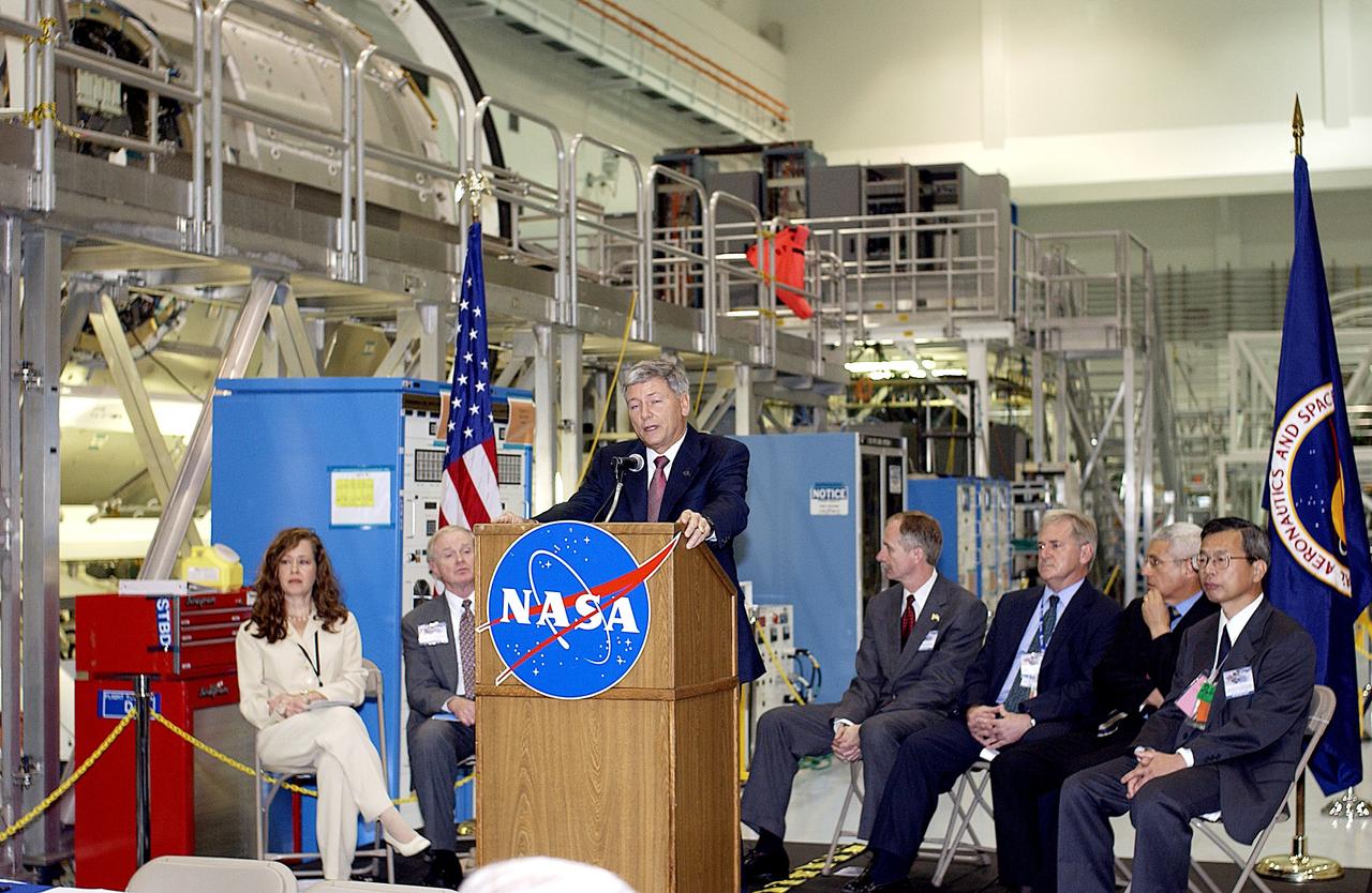 KENNEDY SPACE CENTER, FLA. -  NASA's Michael C. Kostelnik, deputy associate administrator for International Space Station and Shuttle Programs, speaks to guests and the media gathered in the Space Station Processing Facility for a ceremony to highlight the arrival of two major components of the International Space Station.  NASA's Node 2, built by the European Space Agency (ESA) in Italy arrived at KSC on June 1. It will be the next pressurized module installed on the Station. The pressurized module of the Japanese Experiment Module (JEM), named "Kibo" (Hope) arrived at KSC on June 4. It is Japan's primary contribution to the Station. The ceremony held today included the official transfer of ownership signing of Node 2 between the ESA and NASA.. Emceed by Lisa Malone (far left),  deputy director of External Relations and Business Development at KSC, the ceremony also included these speakers: Center Director Roy Bridges Jr. (second from left); William Gerstenmaier, International Space Station Program manager; Alan Thirkettle, International Space Station Program manager for Node 2, ESA; Andrea Lorenzoni, International Space Station Program manager for Node 2, Italian Space Agency; and Kuniaki Shiraki, JEM Project manager, National Aerospace and Development Agency of Japan.