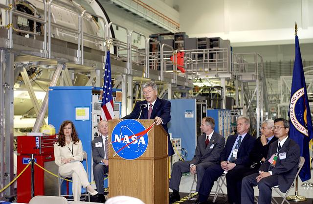NASA image: KENNEDY SPACE CENTER, FLA. -  NASA's Michael C. Kostelnik, deputy associate administrator for International Space Station and Shuttle Programs, speaks to guests and the media gathered in the Space Station Processing Facility for a ceremony to highlight the arrival of two major components of the International Space Station.  NASA's Node 2, built by the European Space Agency (ESA) in Italy arrived at KSC on June 1. It will be the next pressurized module installed on the Station. The pressurized module of the Japanese Experiment Module (JEM), named "Kibo" (Hope) arrived at KSC on June 4. It is Japan's primary contribution to the Station. The ceremony held today included the official transfer of ownership signing of Node 2 between the ESA and NASA.. Emceed by Lisa Malone (far left),  deputy director of External Relations and Business Development at KSC, the ceremony also included these speakers: Center Director Roy Bridges Jr. (second from left); William Gerstenmaier, International Space Station Program manager; Alan Thirkettle, International Space Station Program manager for Node 2, ESA; Andrea Lorenzoni, International Space Station Program manager for Node 2, Italian Space Agency; and Kuniaki Shiraki, JEM Project manager, National Aerospace and Development Agency of Japan.
