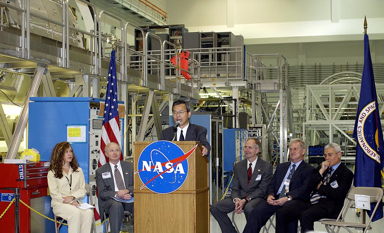 KENNEDY SPACE CENTER, FLA. -  Kuniaki Shiraki, JEM Project manager, National Aerospace and Development Agency of Japan,  speaks to guests and the media gathered in the Space Station Processing Facility at a ceremony highlighting the arrival of two major components of the International Space Station.  NASA's Node 2, built by the European Space Agency (ESA) in Italy, arrived at KSC on June 1. It will be the next pressurized module installed on the Station. The pressurized module of the Japanese Experiment Module (JEM), named "Kibo" (Hope), arrived at KSC on June 4. It is Japan's primary contribution to the Station. The ceremony held today included the official transfer of ownership signing of Node 2 between the ESA and NASA.. Emceed by Lisa Malone (far left), deputy director of External Relations and Business Development at KSC, the ceremony also included these speakers: Center Director Roy Bridges Jr. (second from left); NASA’s Michael C. Kostelnik, deputy associate administrator for International Space Station and Shuttle Programs and William Gerstenmaier, International Space Station Program manager; Alan Thirkettle, International Space Station Program manager for Node 2, ESA; and Andrea Lorenzoni, International Space Station Program manager for Node 2, Italian Space Agency.