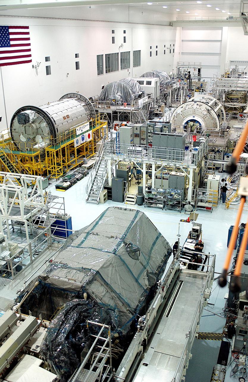 KENNEDY SPACE CENTER, FLA. -  International Space Station elements being processed for launch on upcoming Space Shuttle flights, including the Japanese Experiment Module (JEM) pressurized module (Kibo or Hope) and the U.S. Node 2, line the walls of the high bay in the Space Station Processing Facility.  NASA's Node 2, built by the European Space Agency (ESA) in Italy, arrived at KSC on June 1. It will be the next pressurized module installed on the Station. The JEM pressurized module arrived at KSC on June 4. It is Japan's primary contribution to the Station.