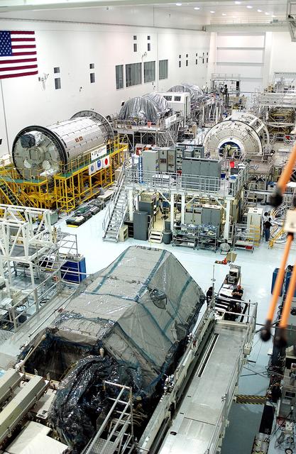 KENNEDY SPACE CENTER, FLA. -  International Space Station elements being processed for launch on upcoming Space Shuttle flights, including the Japanese Experiment Module (JEM) pressurized module (Kibo or Hope) and the U.S. Node 2, line the walls of the high bay in the Space Station Processing Facility.  NASA's Node 2, built by the European Space Agency (ESA) in Italy, arrived at KSC on June 1. It will be the next pressurized module installed on the Station. The JEM pressurized module arrived at KSC on June 4. It is Japan's primary contribution to the Station.