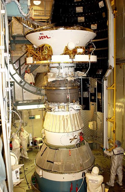 NASA image: KENNEDY SPACE CENTER, FLA. - At Launch Complex 17-B, Cape Canaveral Air Force Station, workers prepare to install the spacecraft fairing around the Mars Exploration Rover-1 (MER-B). The second of twin rovers being sent to Mars, it is equipped with a robotic arm, a drilling tool, three spectrometers, and four pairs of cameras that allow it to have a human-like, 3D view of the terrain. Each rover could travel as far as 100 meters in one day to act as Mars scientists' eyes and hands, exploring an environment where humans are not yet able to go. MER-B is scheduled to launch no earlier than June 28 at one of two available times, 11:56:16 p.m. EDT or 12:37:59 a.m. EDT.
