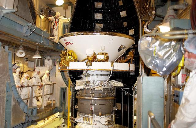 NASA image: KENNEDY SPACE CENTER, FLA. - At Launch Complex 17-B, Cape Canaveral Air Force Station, workers prepare to encapsulate the Mars Exploration Rover-1 (MER-B) into its spacecraft fairing. The second of twin rovers being sent to Mars, it is equipped with a robotic arm, a drilling tool, three spectrometers, and four pairs of cameras that allow it to have a human-like, 3D view of the terrain. Each rover could travel as far as 100 meters in one day to act as Mars scientists' eyes and hands, exploring an environment where humans are not yet able to go. MER-B is scheduled to launch no earlier than June 28 at one of two available times, 11:56:16 p.m. EDT or 12:37:59 a.m. EDT.