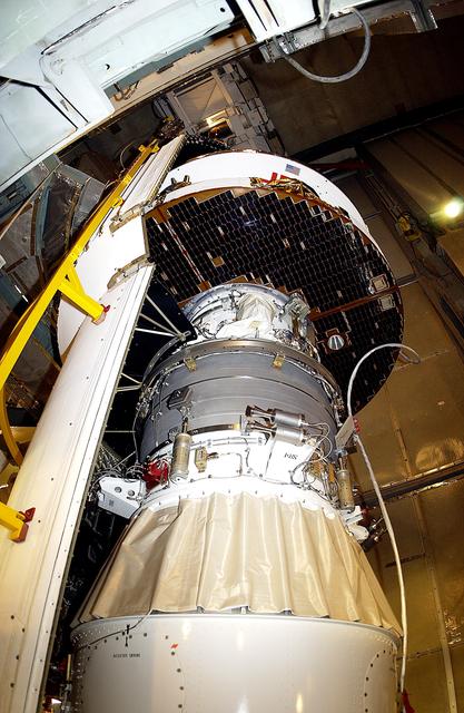 NASA image: KENNEDY SPACE CENTER, FLA. - At Launch Complex 17-B, Cape Canaveral Air Force Station, the spacecraft fairing is being installed around the Mars Exploration Rover-1 (MER-B). The second of twin rovers being sent to Mars, it is equipped with a robotic arm, a drilling tool, three spectrometers, and four pairs of cameras that allow it to have a human-like, 3D view of the terrain. Each rover could travel as far as 100 meters in one day to act as Mars scientists' eyes and hands, exploring an environment where humans are not yet able to go. MER-B is scheduled to launch no earlier than June 28 at one of two available times, 11:56:16 p.m. EDT or 12:37:59 a.m. EDT.