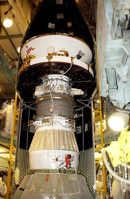 NASA image: KENNEDY SPACE CENTER, FLA. - At Launch Complex 17-B, Cape Canaveral Air Force Station, the spacecraft fairing is being installed around the Mars Exploration Rover-1 (MER-B). The second of twin rovers being sent to Mars, it is equipped with a robotic arm, a drilling tool, three spectrometers, and four pairs of cameras that allow it to have a human-like, 3D view of the terrain. Each rover could travel as far as 100 meters in one day to act as Mars scientists' eyes and hands, exploring an environment where humans are not yet able to go. MER-B is scheduled to launch no earlier than June 28 at one of two available times, 11:56:16 p.m. EDT or 12:37:59 a.m. EDT.