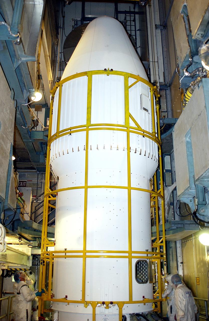 KENNEDY SPACE CENTER, FLA. - At Launch Complex 17-B, Cape Canaveral Air Force Station, workers complete the installation of the spacecraft fairing around the Mars Exploration Rover-1 (MER-B) for launch. The second of twin rovers being sent to Mars, it is equipped with a robotic arm, a drilling tool, three spectrometers, and four pairs of cameras that allow it to have a human-like, 3D view of the terrain. Each rover could travel as far as 100 meters in one day to act as Mars scientists' eyes and hands, exploring an environment where humans are not yet able to go. MER-B is scheduled to launch no earlier than June 28 at one of two available times, 11:56:16 p.m. EDT or 12:37:59 a.m. EDT.