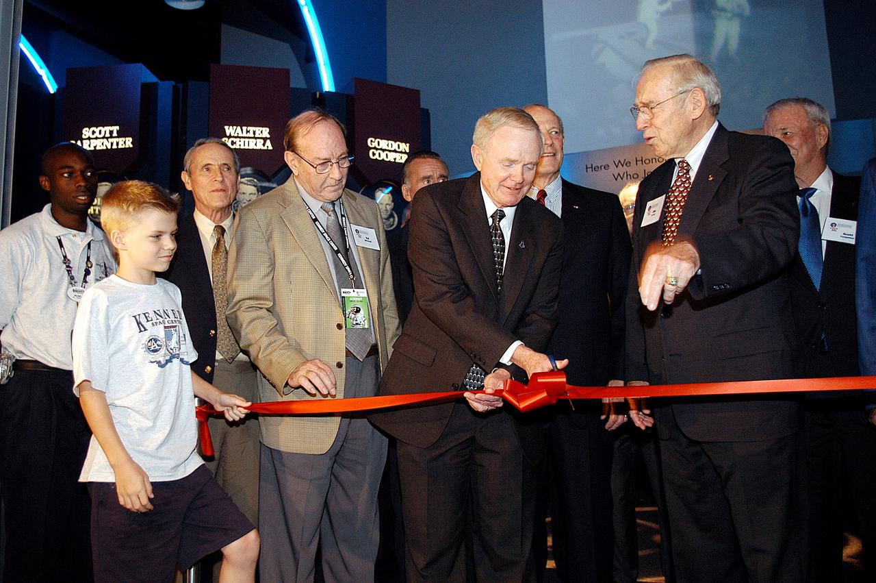 KENNEDY SPACE CENTER, FLA. -  Center Director and former astronaut Roy D. Bridges, Jr., (holding scissors) cuts the ribbon at a ceremony officially opening the U.S. Astronaut Hall of Fame as part of the Kennedy Space Center Visitor Complex.  Invited guests and dignitaries look on, such as former astronauts Edgar D. Mitchell on Bridges' left and James Lovell on his right.  The ceremony was held in conjunction with the induction of four Space Shuttle astronauts into the Hall of Fame including Daniel Brandenstein, Robert "Hoot" Gibson, Story Musgrave, and Sally Ride.  Conceived by six of the Mercury Program astronauts, the U.S. Astronaut Hall of Fame opened in 1990 to provide a place where space travelers could be remembered for their participation and accomplishments in the U.S. space program.  The four new inductees join 48 previously honored astronauts from the ranks of the Gemini, Apollo, Skylab, Apollo-Soyuz, and Space Shuttle programs.