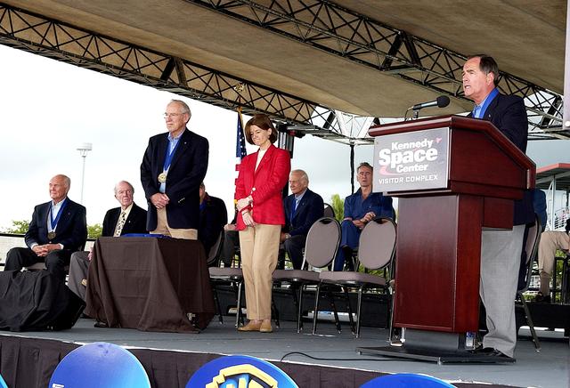 NASA image: KENNEDY SPACE CENTER, FLA. -  At the KSC Visitor Complex, former astronaut Robert L. Crippen (right) presents former astronaut Sally K. Ride (standing center) at her induction ceremony into the U.S. Astronaut Hall of Fame. Also standing is former astronaut James A. Lovell.  Seated on the dais are, from left, former astronauts John H. Glenn, Gordon Cooper, Buzz Aldrin, and Walter Cunningham, all previously inducted into the Hall of Fame. Being inducted with Ride are Space Shuttle astronauts Daniel Brandenstein, Robert "Hoot" Gibson, and Story Musgrave. Conceived by six of the Mercury Program astronauts, the U.S. Astronaut Hall of Fame opened in 1990 to provide a place where space travelers could be remembered for their participation and accomplishments in the U.S. space program. The four new inductees join 48 previously honored astronauts from the ranks of the Gemini, Apollo, Skylab, Apollo-Soyuz, and Space Shuttle programs.