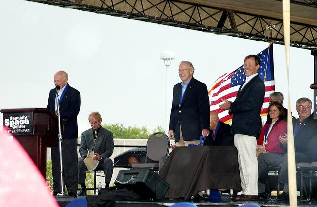 NASA image: KENNEDY SPACE CENTER, FLA. -  At the KSC Visitor Complex, former astronaut John H. Glenn (at podium) presents former astronaut Robert "Hoot" Gibson (standing right) at his induction ceremony into the U.S. Astronaut Hall of Fame. Also standing is former astronaut James A. Lovell.  Seated on the dais, from left, are actor and Master of Ceremonies Lance Henriksen (left), and former astronauts Sally K. Ride and Daniel Brandenstein (right), both inducted into the Hall of Fame today. Also being inducted is Space Shuttle astronaut Story Musgrave. Conceived by six of the Mercury Program astronauts, the U.S. Astronaut Hall of Fame opened in 1990 to provide a place where space travelers could be remembered for their participation and accomplishments in the U.S. space program. The four new inductees join 48 previously honored astronauts from the ranks of the Gemini, Apollo, Skylab, Apollo-Soyuz, and Space Shuttle programs.