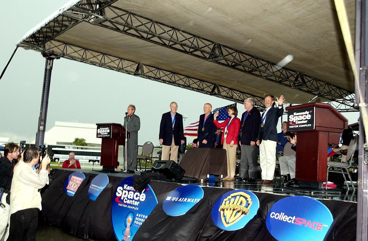 KENNEDY SPACE CENTER, FLA. -  At the KSC Visitor Complex, actor and Master of Ceremonies Lance Henriksen (at podium) introduces four newly inducted Space Shuttle astronauts to the audience at their induction ceremony into the U.S. Astronaut Hall of Fame. From left center, they are Story Musgrave, Sally K. Ride, Daniel Brandenstein, and Robert "Hoot" Gibson. Also standing, left, is former astronaut James A. Lovell.  Conceived by six of the Mercury Program astronauts, the U.S. Astronaut Hall of Fame opened in 1990 to provide a place where space travelers could be remembered for their participation and accomplishments in the U.S. space program. The four new inductees join 48 previously honored astronauts from the ranks of the Gemini, Apollo, Skylab, Apollo-Soyuz, and Space Shuttle programs.