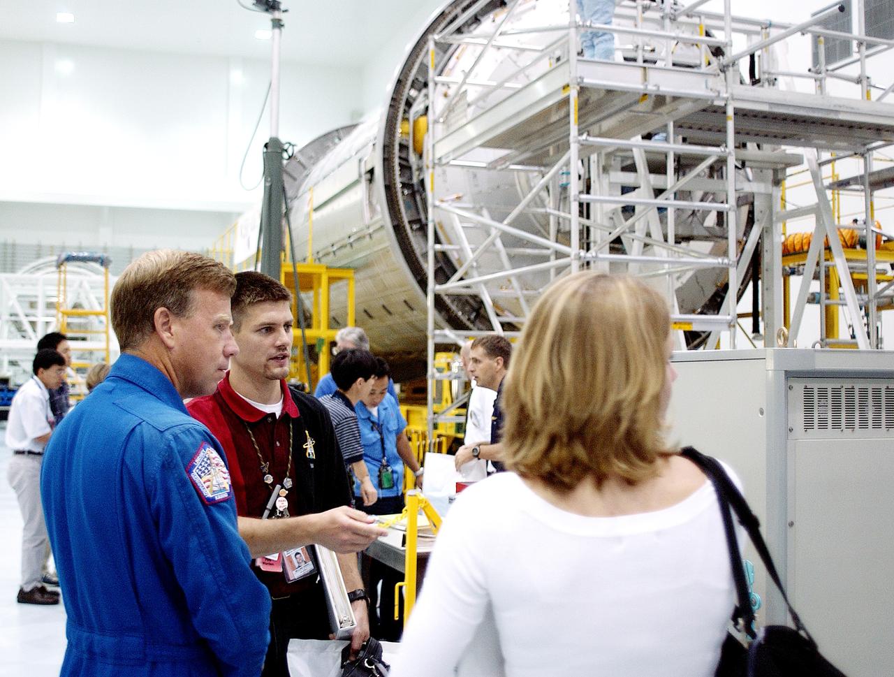 KENNEDY SPACE CENTER, FLA. -  NASA astronaut Steven W. Lindsey (left) listens to a briefing about the pressurized module of the Japanese Experiment Module (JEM) in the Space Station Processing Facility.  This major component of JEM, named "Kibo" (Hope), is Japan's primary contribution to the International Space Station and arrived at KSC on June 4.  Lindsey is assigned to command STS-119, an upcoming Space Shuttle flight to the Station.