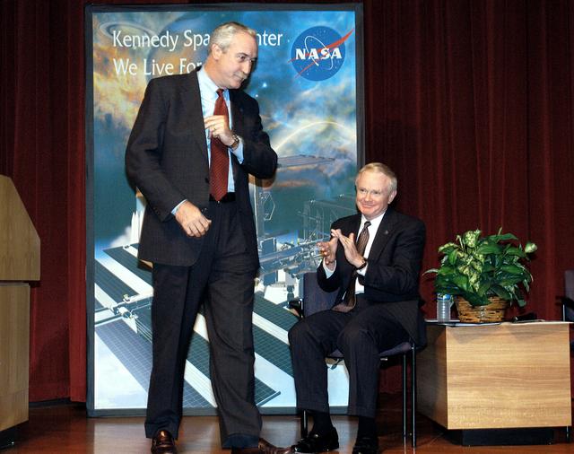 NASA image: KENNEDY SPACE CENTER, FLA. -  NASA Administrator Sean O'Keefe (left) receives the applause of KSC Director Roy D. Bridges (right) and a group of KSC employees assembled in the KSC Training Auditorium.  The occasion is the announcement of James W. Kennedy as the next director of the NASA Kennedy Space Center (KSC) in Florida. Kennedy has served as KSC's deputy director since November 2002. He will succeed Bridges, who was appointed on June 13 to lead NASA's Langley Research Center, Hampton, Va.