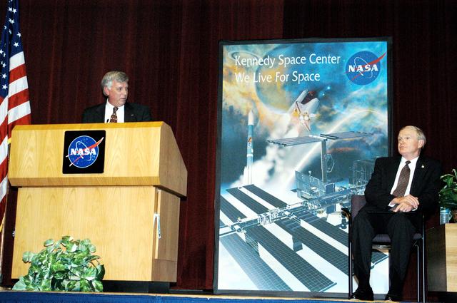 KENNEDY SPACE CENTER, FLA. -  KSC Deputy Director James W. Kennedy addresses a group of KSC employees assembled in the KSC Training Auditorium, as KSC Director Roy D. Bridges looks on (right). The occasion is the announcement of Kennedy as the next director of the NASA Kennedy Space Center (KSC) in Florida. Kennedy has served as KSC's deputy director since November 2002. He will succeed Bridges, who was appointed on June 13 to lead NASA's Langley Research Center, Hampton, Va.