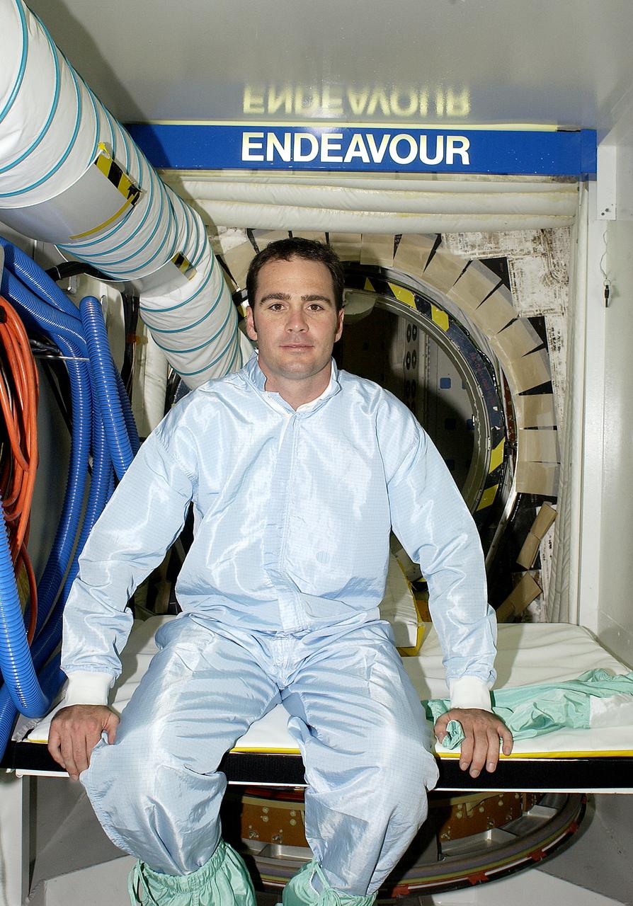 NASCAR driver Jimmie Johnson poses outside the hatch of orbiter Endeavour. Johnson and other drivers Ryan Newman and Dale Jarrett were on a tour of KSC. The men are scheduled to drive in the Pepsi 400 auto race being held July 5 at the Daytona International Speedway, Daytona Beach.