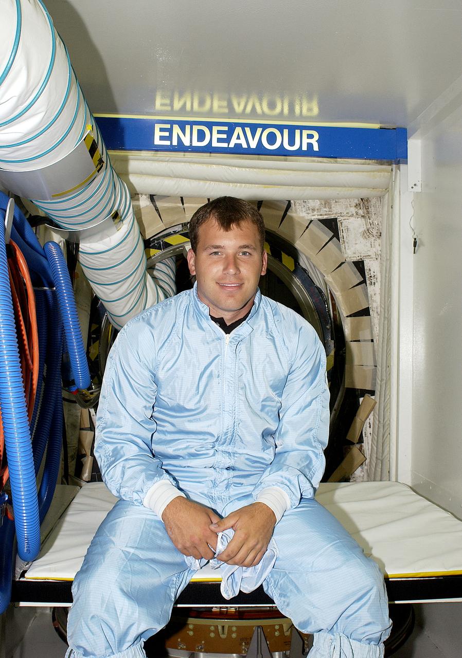NASCAR driver Dale Jarrett poses outside the hatch of orbiter Endeavour. Jarrett and other drivers Ryan Newman and Jimmie Johnson were on a tour of KSC. The men are scheduled to drive in the Pepsi 400 auto race being held July 5 at the Daytona International Speedway, Daytona Beach.