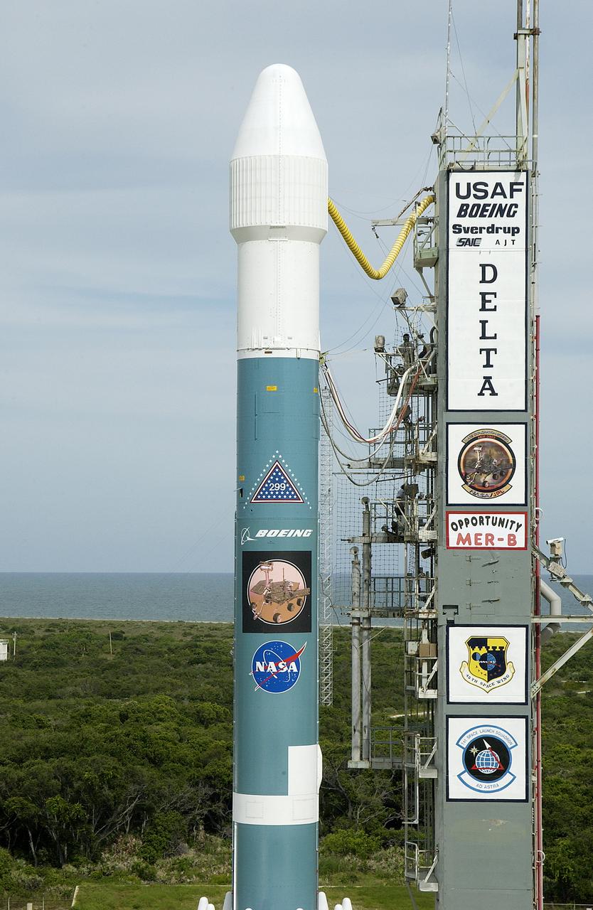 On Launch Complex 17-B, Cape Canaveral Air Force Station, the Delta II Heavy launch vehicle carrying the rover "Opportunity" for the second Mars Exploration Rover mission is poised for launch after rollback of the Mobile Service Tower. Opportunity will reach Mars on Jan. 25, 2004. Together the two MER rovers, Spirit (launched June 10) and Opportunity, seek to determine the history of climate and water at two sites on Mars where conditions may once have been favorable to life. The rovers are identical. They will navigate themselves around obstacles as they drive across the Martian surface, traveling up to about 130 feet each Martian day. Each rover carries five scientific instruments including a panoramic camera and microscope, plus a rock abrasion tool that will grind away the outer surfaces of rocks to expose their interiors for examination. Each rover’s prime mission is planned to last three months on Mars.
