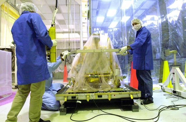 NASA image: KENNEDY SPACE CENTER, FLA. -  Workers at Vandenberg Air Force Base, Calif., prepare to move the SciSat-1 spacecraft.  SciSat-1 weighs approximately 330 pounds and will be placed in a 400-mile-high polar orbit to investigate processes that control the distribution of ozone in the upper atmosphere.  The scientific mission of SciSat-1 is to measure and understand the chemical processes that control the distribution of ozone in the Earth’s atmosphere, particularly at high altitudes.  The data from the satellite will provide Canadian and international scientists with improved measurements relating to global ozone processes and help policymakers assess existing environmental policy and develop protective measures for improving the health of our atmosphere, preventing further ozone depletion.  The mission is designed to last two years.