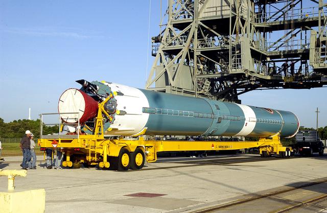 NASA image: KENNEDY SPACE CENTER, FLA. -   On Launch Complex 17-B, Cape Canaveral Air Force Station, the first stage of a Delta II rocket waits to be lifted up and moved into the mobile service tower.  The rocket is being erected to launch the Space InfraRed Telescope Facility (SIRTF).  Consisting of an 0.85-meter telescope and three cryogenically cooled science instruments, SIRTF is one of NASA's largest infrared telescopes to be launched.  SIRTF will obtain images and spectra by detecting the infrared energy, or heat, radiated by objects in space. Most of this infrared radiation is blocked by the Earth's atmosphere and cannot be observed from the ground.