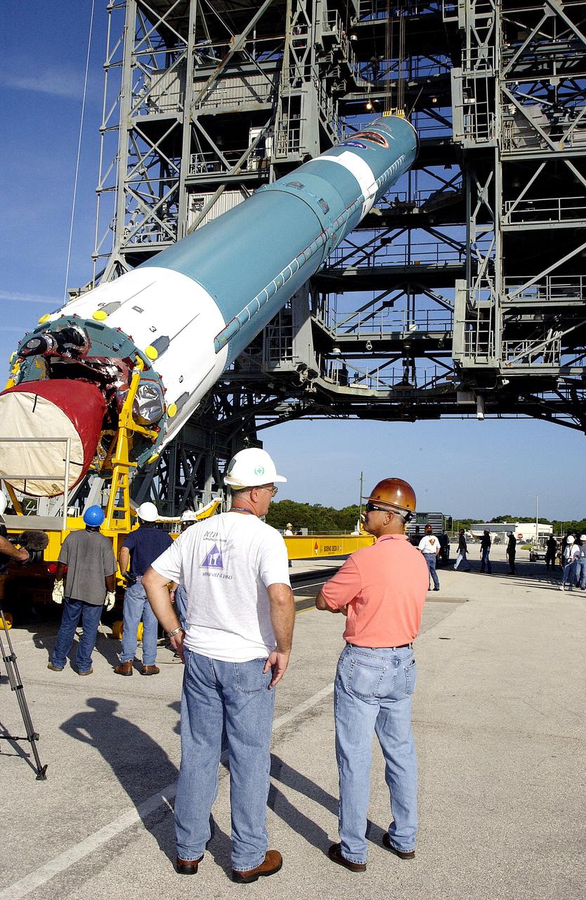 KENNEDY SPACE CENTER, FLA. -   On Launch Complex 17-B, Cape Canaveral Air Force Station, the first stage of a Delta II rocket is raised off the transporter before lifting it up and moved into the mobile service tower.  The rocket is being erected to launch the Space InfraRed Telescope Facility (SIRTF).  Consisting of an 0.85-meter telescope and three cryogenically cooled science instruments, SIRTF is one of NASA's largest infrared telescopes to be launched.  SIRTF will obtain images and spectra by detecting the infrared energy, or heat, radiated by objects in space. Most of this infrared radiation is blocked by the Earth's atmosphere and cannot be observed from the ground.