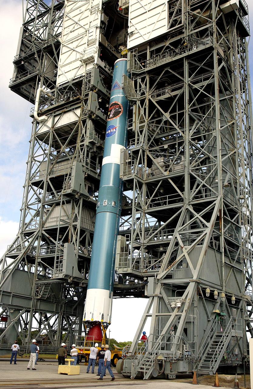 KENNEDY SPACE CENTER, FLA. -   On Launch Complex 17-B, Cape Canaveral Air Force Station, the first stage of a Delta II rocket is moved into the mobile service tower.  The rocket is being erected to launch the Space InfraRed Telescope Facility (SIRTF).  Consisting of an 0.85-meter telescope and three cryogenically cooled science instruments, SIRTF is one of NASA's largest infrared telescopes to be launched.  SIRTF will obtain images and spectra by detecting the infrared energy, or heat, radiated by objects in space. Most of this infrared radiation is blocked by the Earth's atmosphere and cannot be observed from the ground.