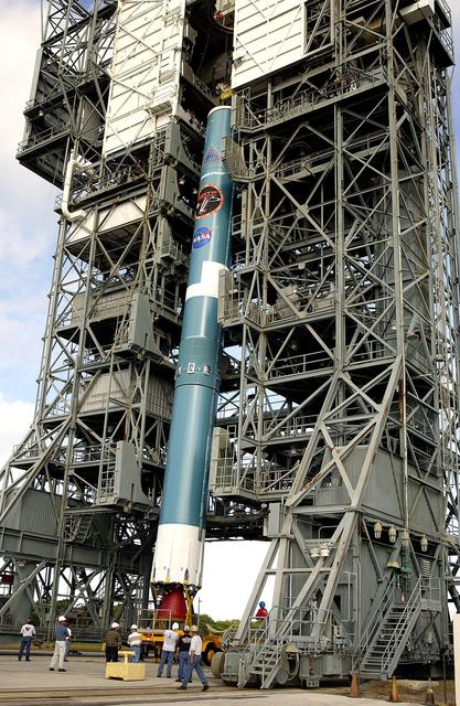 NASA image: KENNEDY SPACE CENTER, FLA. -   On Launch Complex 17-B, Cape Canaveral Air Force Station, the first stage of a Delta II rocket is moved into the mobile service tower.  The rocket is being erected to launch the Space InfraRed Telescope Facility (SIRTF).  Consisting of an 0.85-meter telescope and three cryogenically cooled science instruments, SIRTF is one of NASA's largest infrared telescopes to be launched.  SIRTF will obtain images and spectra by detecting the infrared energy, or heat, radiated by objects in space. Most of this infrared radiation is blocked by the Earth's atmosphere and cannot be observed from the ground.