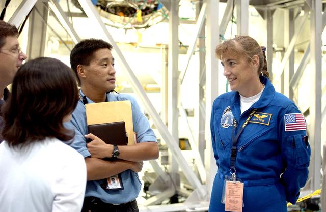 NASA image: KENNEDY SPACE CENTER, FLA. -  STS-115 Mission Specialist Heidemarie Stefanyshyn-Piper talks to workers in the Space Station Processing Facility.  She and other crew members are at KSC for hardware familiarization.  The mission will deliver the second port truss segment, the P3/P4 Truss, to attach to the first port truss segment, the P1 Truss, as well as deploy solar array sets 2A and 4A..  The crew is scheduled to activate and check out the Solar Alpha Rotary Joint (SARJ) and deploy the P4 Truss radiator.