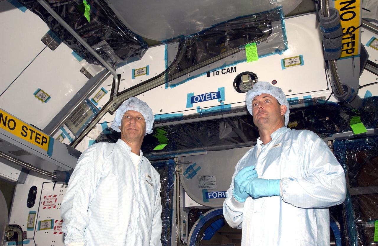 KENNEDY SPACE CENTER, FLA. -    STS-120 Mission Specialists Piers Sellers and Michael Foreman check out the inside of the Japanese Experiment Module (JEM) Pressurized Module located in the Space Station Processing Facility. Known as Kibo, the JEM consists of six components: two research facilities -- the Pressurized Module and Exposed Facility; a Logistics Module attached to each of them; a Remote Manipulator System; and an Inter-Orbit Communication System unit. Kibo also has a scientific airlock through which experiments are transferred and exposed to the external environment of space. The various components of JEM will be assembled in space over the course of three Space Shuttle missions.  The STS-120 mission will deliver the second of three Station connecting modules, Node 2, which attaches to the end of U.S. Lab.  It will provide attach locations for the JEM, European laboratory, the Centrifuge Accommodation Module and later Multi-Purpose Logistics Modules.  The addition of Node 2 will complete the U.S. core of the International Space Station.