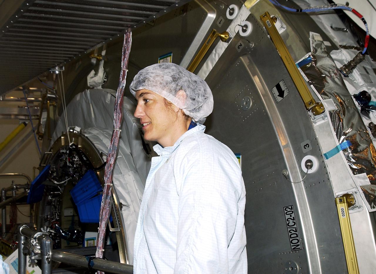 KENNEDY SPACE CENTER, FLA. - In the Space Station Processing Facility, STS-115 Mission Specialist Heidemarie Stefanyshyn-Piper (left) gets ready to check out the Japanese Experiment Module (JEM) Pressurized Module. Known as Kibo, the JEM consists of six components: two research facilities -- the Pressurized Module and Exposed Facility; a Logistics Module attached to each of them; a Remote Manipulator System; and an Inter-Orbit Communication System unit. Kibo also has a scientific airlock through which experiments are transferred and exposed to the external environment of space. The various components of JEM will be assembled in space over the course of three Space Shuttle missions. The STS-115 mission will deliver the second port truss segment, the P3/P4 Truss, to attach to the first port truss segment, the P1 Truss, as well as deploy solar array sets 2A and 4A.. The crew is scheduled to activate and check out the Solar Alpha Rotary Joint (SARJ) and deploy the P4 Truss radiator.