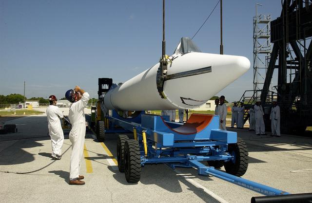 NASA image: KENNEDY SPACE CENTER, FLA. -   On Launch Complex 17-B, Cape Canaveral Air Force Station, another solid rocket booster (SRB) is being raised from its transporter to lift it to vertical.  It is one of nine  46-inch-diameter, stretched SRBs that are being attached to the Delta II Heavy rocket that will launch the Space Infrared Telescope Facility (SIRTF).  Consisting of three cryogenically cooled science instruments and an 0.85-meter telescope, SIRTF is one of NASA's largest infrared telescopes to be launched.  SIRTF will obtain images and spectra by detecting the infrared energy, or heat, radiated by objects in space. Most of this infrared radiation is blocked by the Earth's atmosphere and cannot be observed from the ground.