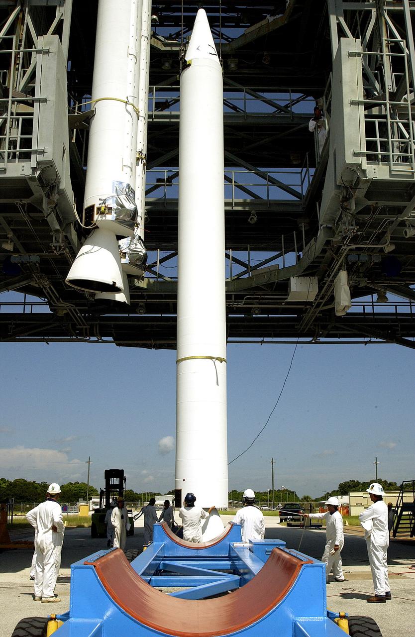 KENNEDY SPACE CENTER, FLA. -   On Launch Complex 17-B, Cape Canaveral Air Force Station, a solid rocket booster (SRB) is lifted into the mobile service tower, joining two others.  They are three of nine  46-inch-diameter, stretched SRBs that are being attached to the Delta II Heavy rocket that will launch the Space Infrared Telescope Facility (SIRTF).  Consisting of three cryogenically cooled science instruments and an 0.85-meter telescope, SIRTF is one of NASA's largest infrared telescopes to be launched.  SIRTF will obtain images and spectra by detecting the infrared energy, or heat, radiated by objects in space. Most of this infrared radiation is blocked by the Earth's atmosphere and cannot be observed from the ground.
