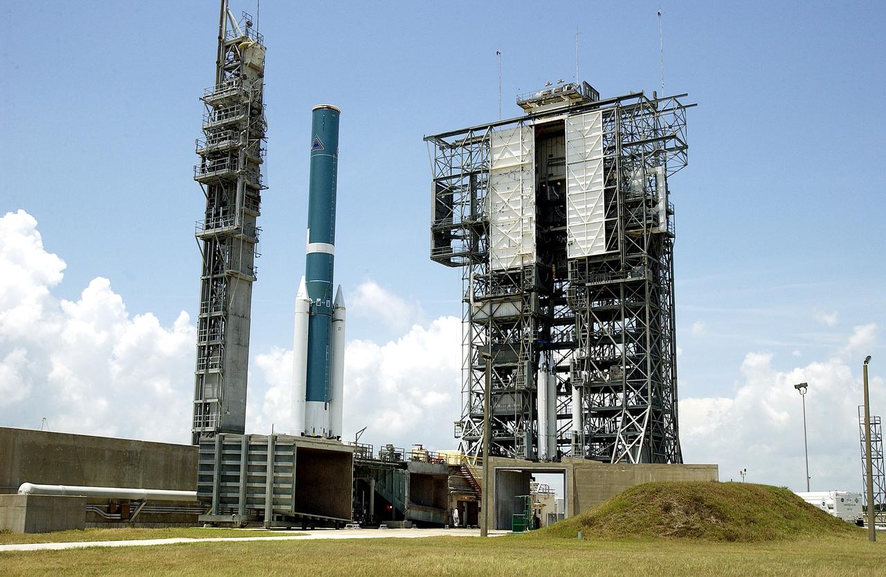 KENNEDY SPACE CENTER, FLA. -   On Launch Complex 17-B, Cape Canaveral Air Force Station, the Delta II Heavy rocket waits the arrival of the mobile service tower with three additional solid rocket boosters (SRBs).  Nine 46-inch-diameter, stretched SRBs will help launch the Space Infrared Telescope Facility (SIRTF).  Consisting of three cryogenically cooled science instruments and an 0.85-meter telescope, SIRTF is one of NASA's largest infrared telescopes to be launched.  SIRTF will obtain images and spectra by detecting the infrared energy, or heat, radiated by objects in space. Most of this infrared radiation is blocked by the Earth's atmosphere and cannot be observed from the ground.