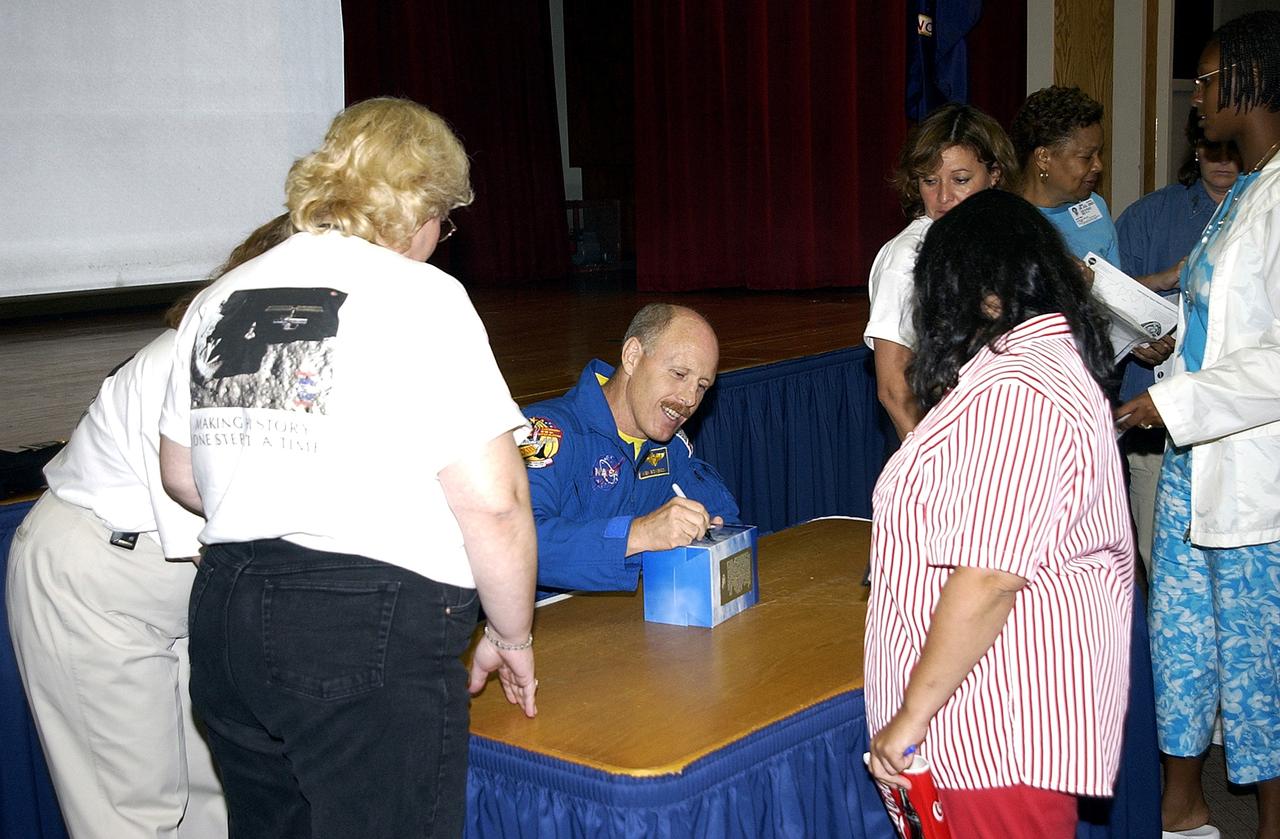KENNEDY SPACE CENTER, FLA. -   Expedition 6 Commander Ken Bowersox happily signs autographs for KSC employees after his presentation about his mission and residence on the International Space Station from November 25, 2002, to May 3, 2003.