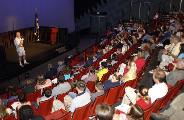 NASA image: KENNEDY SPACE CENTER, FLA.  -  Former astronaut Story Musgrave talks to employees and their children during a welcome ceremony in the IMAX Theatre, KSC Visitor Complex.  Employees were invited to share their work experience with their children for Take Our Children to Work Day.