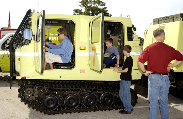 NASA image: KENNEDY SPACE CENTER, FLA.  -   Children enjoy a hands-on display of fire equipment behind KSC NASA Headquarters.  Employees were invited to share their work experience with their children for Take Our Children to Work Day.