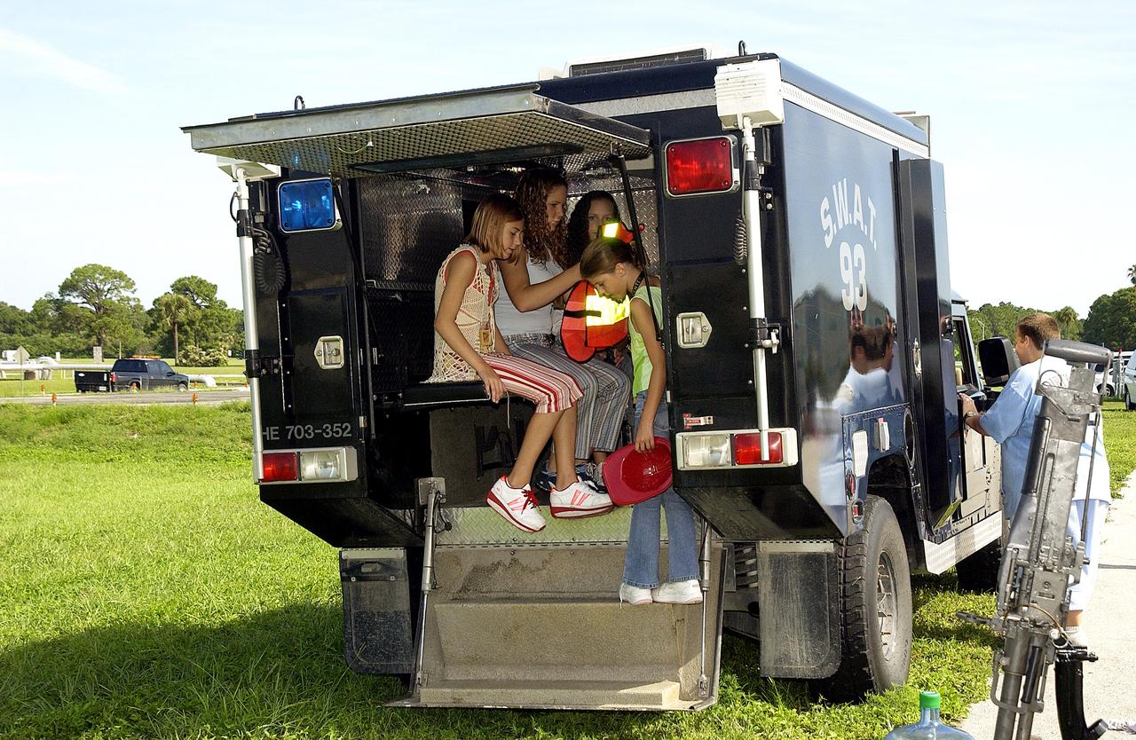 KENNEDY SPACE CENTER, FLA.  -    Children enjoy a hands-on display of security equipment during Take Our Children to Work Day.  Employees were invited to share their work experience with their children on this annual event.