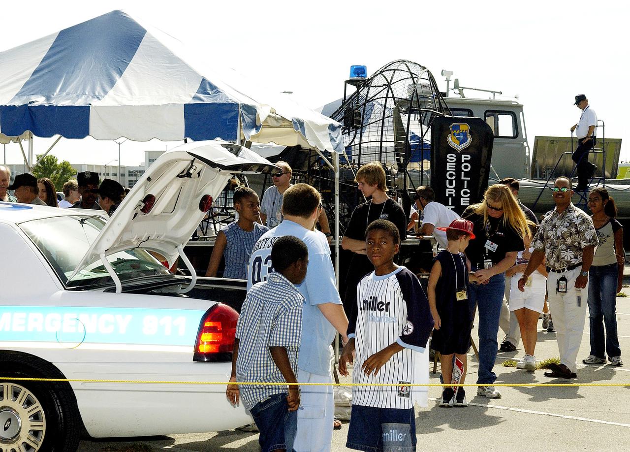 KENNEDY SPACE CENTER, FLA.  -   Children enjoy displays of security equipment during Take Our Children to Work Day.  Employees were invited to share their work experience with their children on this annual event.