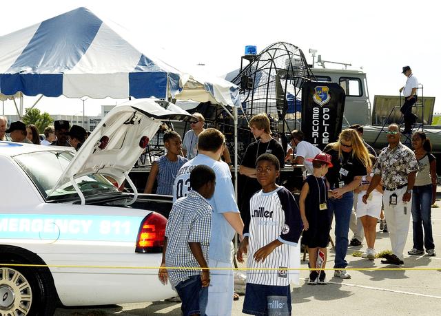NASA image: KENNEDY SPACE CENTER, FLA.  -   Children enjoy displays of security equipment during Take Our Children to Work Day.  Employees were invited to share their work experience with their children on this annual event.