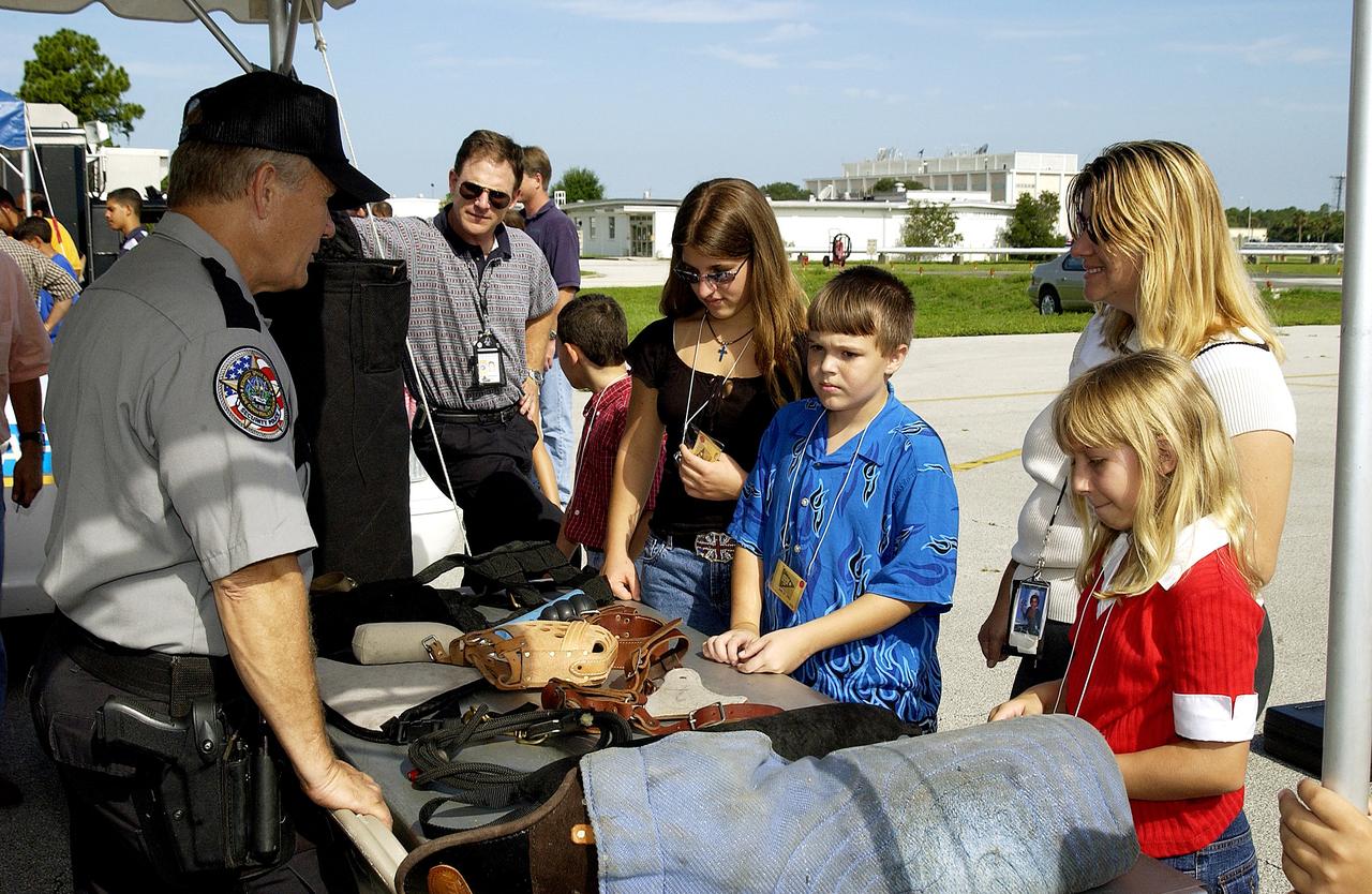 KENNEDY SPACE CENTER, FLA.  -  Children enjoy displays of security equipment during Take Our Children to Work Day.  Employees were invited to share their work experience with their children on this annual event.