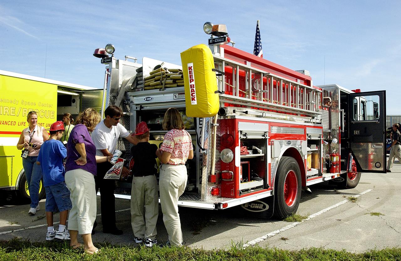KENNEDY SPACE CENTER, FLA.  -  Children enjoy displays of fire equipment during Take Our Children to Work Day.  Employees were invited to share their work experience with their children on this annual event.