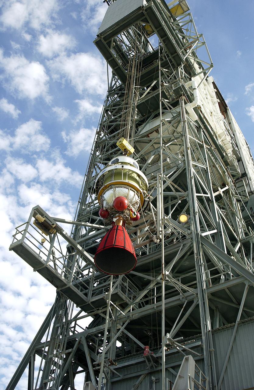 The second stage of the Delta II Heavy rocket is lifted up the mobile service tower on Launch Complex 17-B, Cape Canaveral Air Force Station for mating with the first stage. The rocket will launch the Space Infrared Telescope Facility (SIRTF), currently scheduled for mid-August. SIRTF consists of three cryogenically cooled science instruments and an 0.85-meter telescope, and is one of NASA's largest infrared telescopes to be launched. SIRTF will obtain images and spectra by detecting the infrared energy, or heat, radiated by objects in space. Most of this infrared radiation is blocked by the Earth's atmosphere and cannot be observed from the ground.