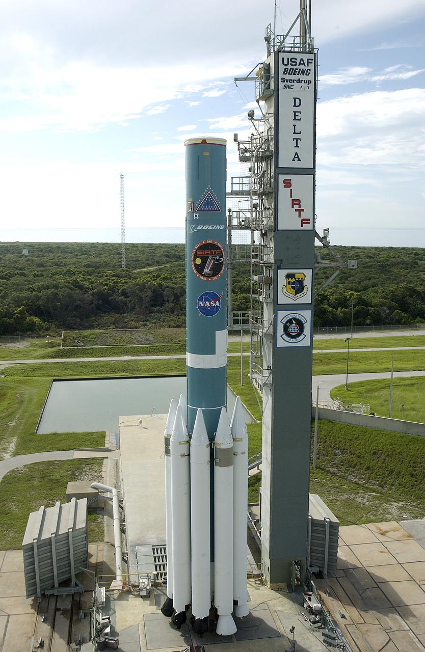 The first stage of the rocket with its nine solid rocket boosters waits on Launch Complex 17-B, Cape Canaveral Air Force Station, for mating with the second stage. The rocket will launch the Space Infrared Telescope Facility (SIRTF), currently scheduled for mid-August. SIRTF consists of three cryogenically cooled science instruments and an 0.85-meter telescope, and is one of NASA's largest infrared telescopes to be launched. SIRTF will obtain images and spectra by detecting the infrared energy, or heat, radiated by objects in space. Most of this infrared radiation is blocked by the Earth's atmosphere and cannot be observed from the ground.