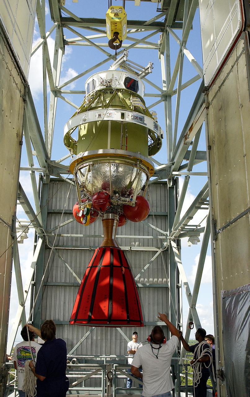 The second stage of the Delta II Heavy rocket is lifted into the mobile service tower on Launch Complex 17-B, Cape Canaveral Air Force Station, where it will be mated to the first stage. The rocket will launch the Space Infrared Telescope Facility (SIRTF), currently scheduled for mid-August. SIRTF consists of three cryogenically cooled science instruments and an 0.85-meter telescope, and is one of NASA's largest infrared telescopes to be launched. SIRTF will obtain images and spectra by detecting the infrared energy, or heat, radiated by objects in space. Most of this infrared radiation is blocked by the Earth's atmosphere and cannot be observed from the ground.