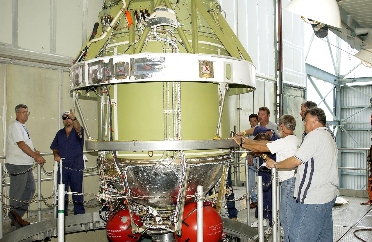 The second stage of the Delta II Heavy rocket is ready for mating onto the first stage, below. The rocket will launch the Space Infrared Telescope Facility (SIRTF), currently scheduled for mid-August. SIRTF consists of three cryogenically cooled science instruments and an 0.85-meter telescope, and is one of NASA's largest infrared telescopes to be launched. SIRTF will obtain images and spectra by detecting the infrared energy, or heat, radiated by objects in space. Most of this infrared radiation is blocked by the Earth's atmosphere and cannot be observed from the ground.